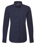 A navy blue, long-sleeved, button-up dress shirt with a collar from Shirts is displayed on a plain white background.