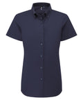 A navy blue short-sleeved shirt with a collar and centre front buttons, featuring a structured fit, displayed on a plain white background.