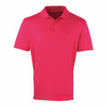 A vibrant Premier PR615 polo shirt, featuring short sleeves and a collar, is neatly folded against a plain white background, showcasing its smooth and lightweight fabric.