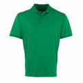 The PR615 by Premier is a plain green polo shirt featuring a collar and three buttons down the front. It is short-sleeved and displayed against a white background.