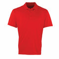 A Premier PR615 shirt displayed against a white background, featuring a plain red design with short sleeves and a collar with a three-button placket.