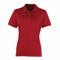 A plain red Premier PR616 polo shirt featuring a collar and three buttons on the front, displayed against a white background.