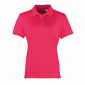 A Premier PR616 polo shirt in vibrant pink, featuring short sleeves, a collar, and three buttons, showcased against a plain white background.