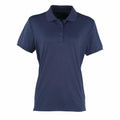 The Premier PR616 is a simple, dark blue short-sleeve polo shirt featuring a collar and three buttons, displayed against a white background.