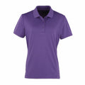The PR616 by Premier is a plain purple polo shirt featuring short sleeves, a collar, and a three-button placket. It is displayed against a simple white background.