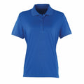 The PR616 by Premier is a plain blue polo shirt featuring short sleeves and a button-up collar, showcased against a white background.