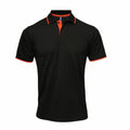 The Premier PR618 is a black polo shirt with an orange trim on the collar and sleeves, featuring a buttoned placket.