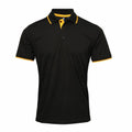The product showcased is the Premier PR618, a black polo shirt featuring a yellow-trimmed collar and cuffs. This shirt includes buttons at the neckline, short sleeves, and is crafted from a lightweight, breathable fabric.
