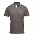 Introducing the PR618 polo shirt from Premier, featuring a gray design with short sleeves and a button-up collar. This shirt boasts a smooth texture accented by white trim on the collar and sleeve edges, complemented by black buttons. The simple elegance of this piece stands out against its plain white background.