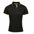 The Premier PR619 black polo shirt features short sleeves and lime green accents on the collar and cuffs.