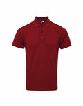 A Premier PR630 polo shirt featuring a collar and three buttons in plain red.