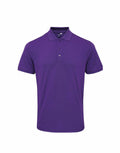 The Premier PR630 is a plain purple polo shirt featuring short sleeves and a buttoned collar, displayed against a white background.