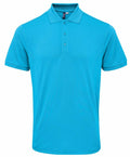 Introducing the Premier PR630—a stylish blue short-sleeve polo shirt featuring a collar and three buttons. This shirt boasts a sleek, plain design and is displayed against a clean white background.
