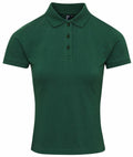The Premier PR632, a green polo shirt featuring short sleeves and a buttoned collar, is showcased against a white background.