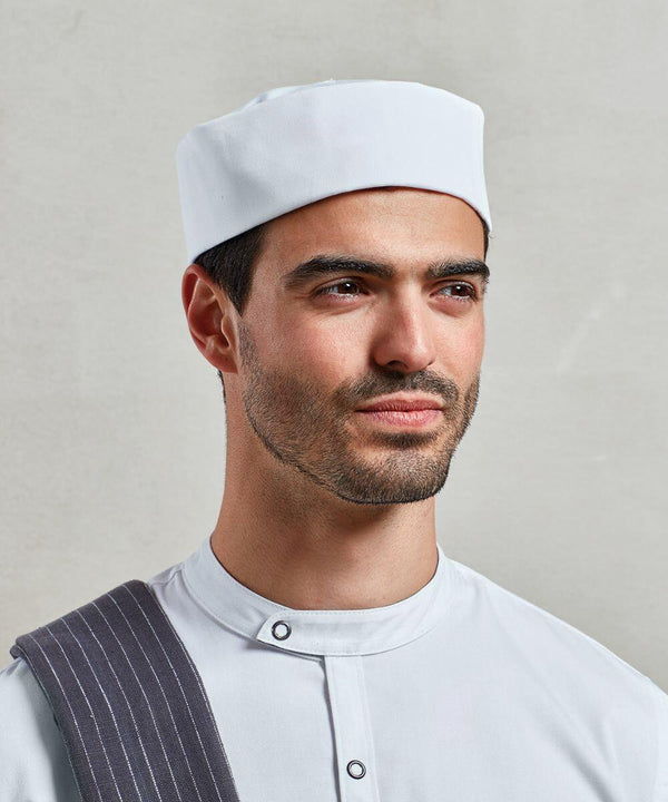 A man, wearing a white chef hat and a white uniform with a dark-striped towel over his shoulder, is looking slightly to the side against a plain background with the Premier PR648.