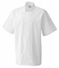 The Premier PR656 is a white chef's jacket featuring short sleeves, a double-breasted front, and button details.