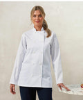 A person wearing a white chef's coat stands in front of a light background, resting one hand on a marble surface featuring Premier's PR671.
