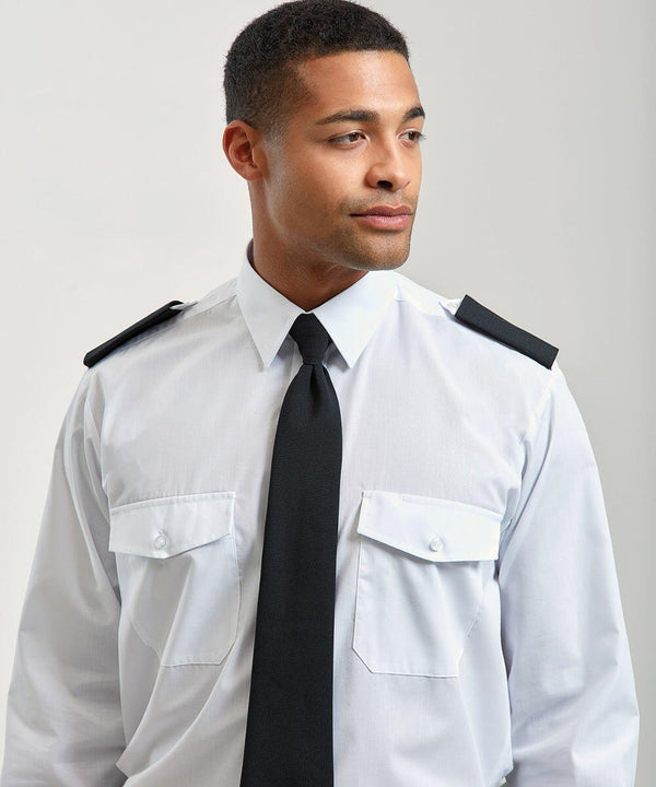 An individual wearing a white dress shirt with black epaulettes and a black tie, looking off to the side against a plain background, is showcasing the Premier PR700.
