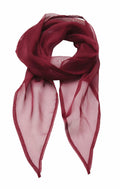 A sheer scarf from Premier, known as the PR740, is elegantly draped to form a loop at the top with flowing ends. Its lightweight burgundy fabric displays a delicate and translucent texture.