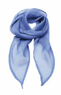 The Premier PR740 scarf features a light blue hue and is elegantly folded with draped, pointed ends. The translucent fabric is soft to the touch and displays a subtle sheen.