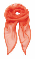 The Premier PR740 scarf is elegantly arranged with its two ends crossing at the bottom, forming a loop at the top. Its lightweight and slightly translucent orange fabric stands out against a white background.