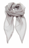 The Premier PR740 light gray sheer chiffon scarf is elegantly arranged with a soft knot at the top, allowing the fabric to drape loosely. Its translucent texture adds a delicate touch to its appearance.