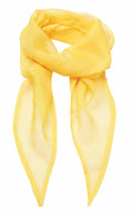 The Premier PR740 chiffon scarf, in a vibrant yellow hue, is showcased set against a white background. It is elegantly folded in a relaxed loop with two ends draping down. The scarf looks lightweight and translucent, featuring a smooth texture.