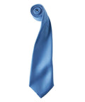 Introducing the PR750 by Premier: a rolled necktie in a sleek blue with a lustrous sheen, elegantly presented on a white backdrop.