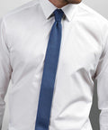 A man wearing a Premier PR789 white dress shirt and a blue textured tie.