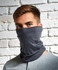 Person wearing a grey Premier PR798 mask covering the lower half of their face, standing against a white brick wall.