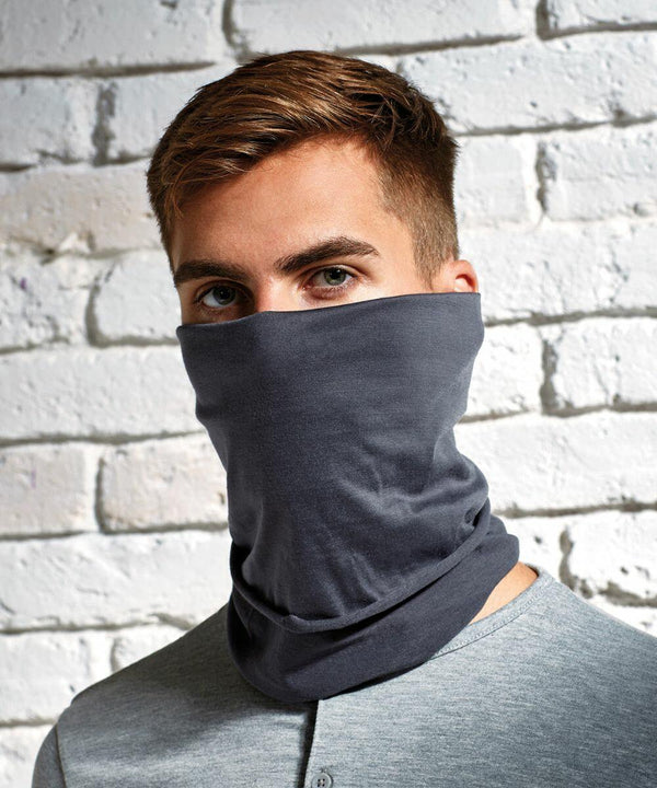 Person wearing a grey Premier PR798 mask covering the lower half of their face, standing against a white brick wall.