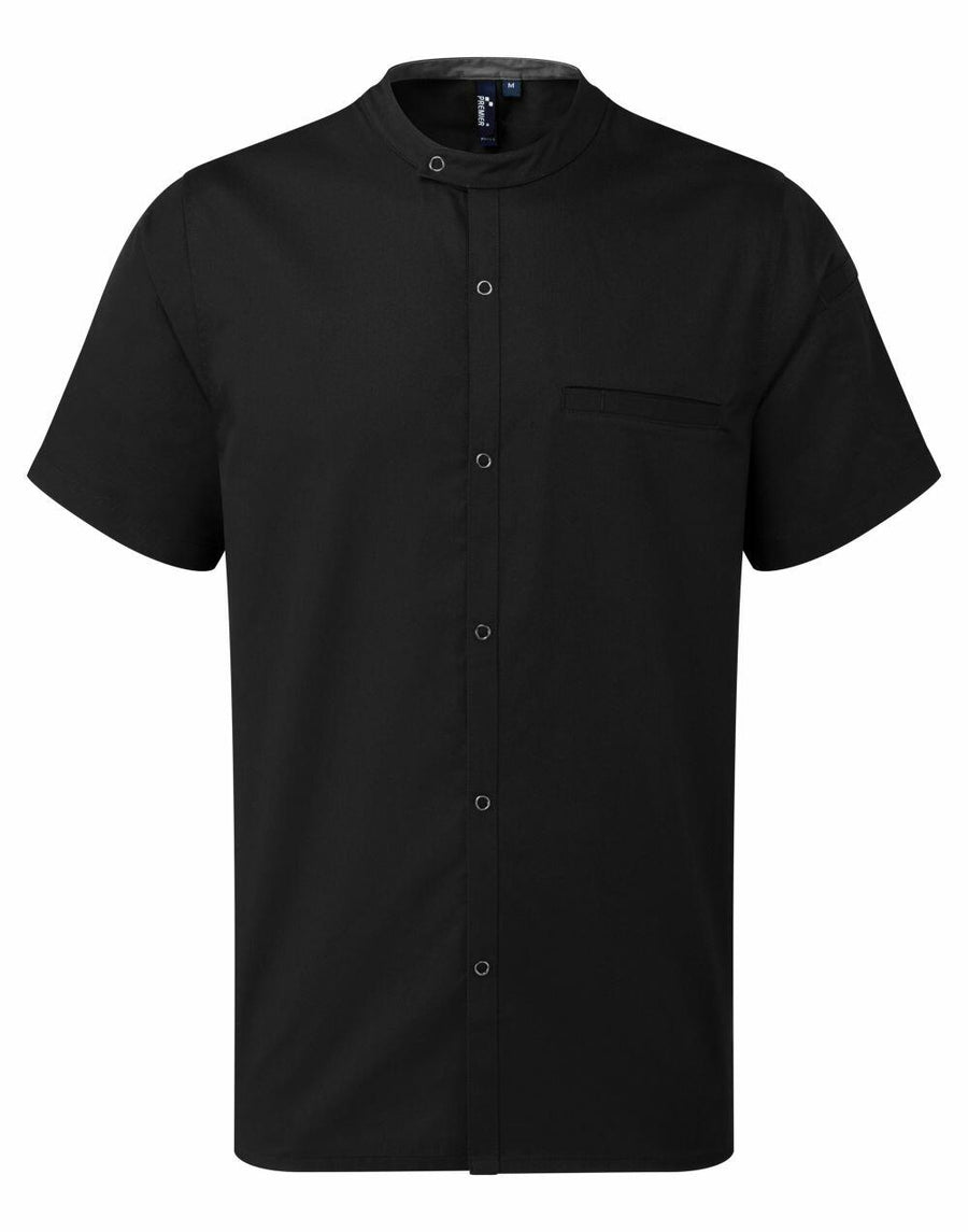 The Premier PR904 is a black short-sleeve shirt featuring a mandarin collar, buttoned front, and a single chest pocket on the left side.