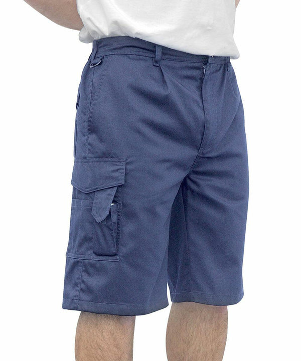 A person wearing blue Portwest PW122 cargo shorts and a white shirt, standing with hands behind their back. The shorts have multiple pockets.