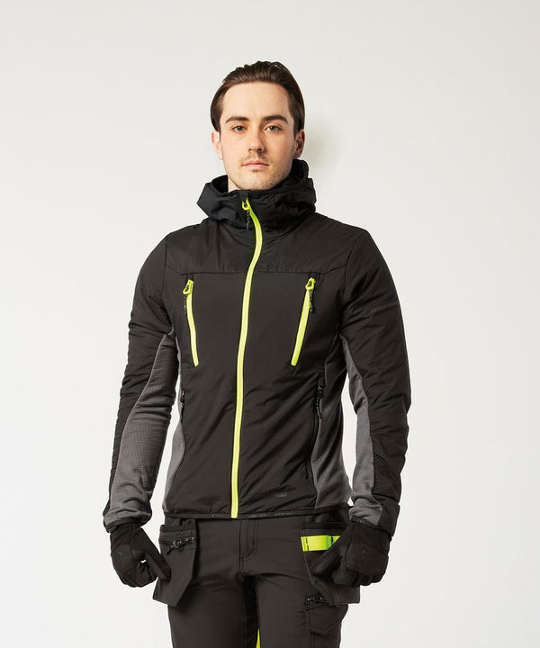 A man faces forwards against a white background, wearing the Portwest EV4 Insulated hybrid jacket (EV470) in black with neon yellow zips, matching trousers with yellow accents, and black gloves.