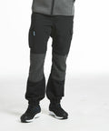 Person wearing black and gray athletic pants with pockets (PW291 from Portwest) and black athletic shoes, standing against a plain white background.
