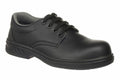 The PW300 by Portwest is a black leather work shoe featuring a low-cut design, lace-up closure, and cushioned collar.