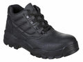 The Portwest PW302 is a black work boot featuring metal eyelets, padded ankle support, and a thick, textured sole.