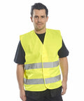 A person wearing a yellow Portwest PW333 high-visibility safety vest over a black shirt stands facing forward.