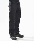 A person wearing Portwest PW342 work pants and black shoes stands against a plain white background.