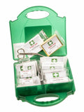 The Portwest PW355 first aid kit in green is open, showcasing an assortment of medical supplies such as bandages, sterile dressings, an eye pad, and scissors.