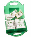 An open green first aid kit containing PW355 by Portwest, including bandages, sterile dressings, eye pads, alcohol-free wipes, and a pair of scissors.
