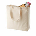 Quadra's cream-colored QD023 tote bag with handles, featuring a magazine and a spiral notebook inside.