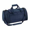 The Quadra QD070 is a navy blue duffel bag featuring both handles and a detachable shoulder strap.