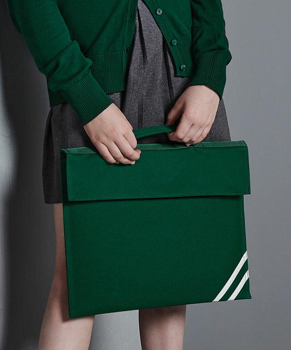 Person holding a Quadra QD456 green fabric briefcase with two white stripes in front of their body, wearing a green sweater and grey skirt.