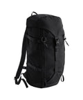 The Bags rucksack is large and black, featuring adjustable shoulder straps, buckle fastenings, side compression straps, and a top flap, shown against a plain white background.