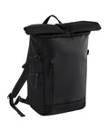 The Bags rucksack is black with a roll-top design, front zipped pocket, adjustable shoulder straps, and a top handle, displayed against a white background.