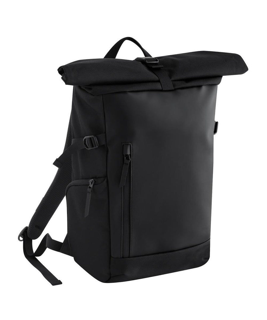 The Bags rucksack is black with a roll-top design, front zipped pocket, adjustable shoulder straps, and a top handle, displayed against a white background.