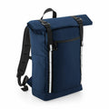 A navy blue backpack from Quadra's QD552 collection, featuring a roll-top design, black straps, and reflective strips on the front.