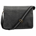 The Quadra QD610 is a black fabric messenger bag featuring a dark gray adjustable strap and a brass buckle.