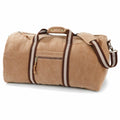 The Quadra QD613 is a tan canvas duffel bag featuring brown and white striped handles, a front zipper pocket, and an adjustable shoulder strap.